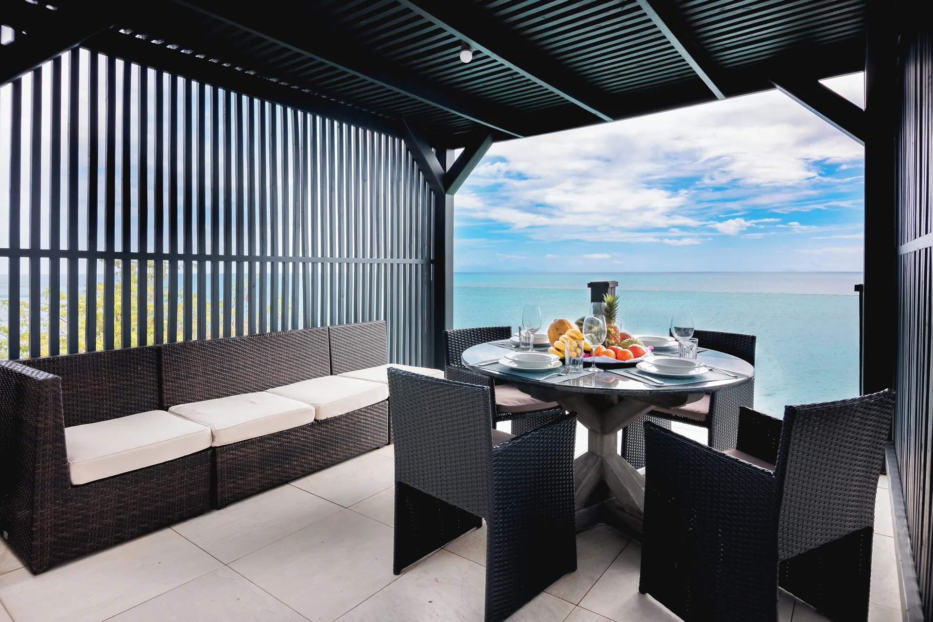 Covered sea-view terrace dining area at Tamarind Hills Resort & Villas.