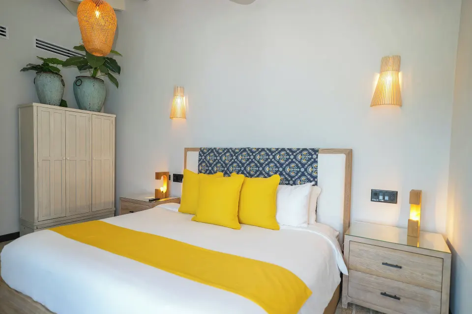 Ocean 19 king bed with patterned headboard and wardrobe at Tamarind Hills Resort & Villas.