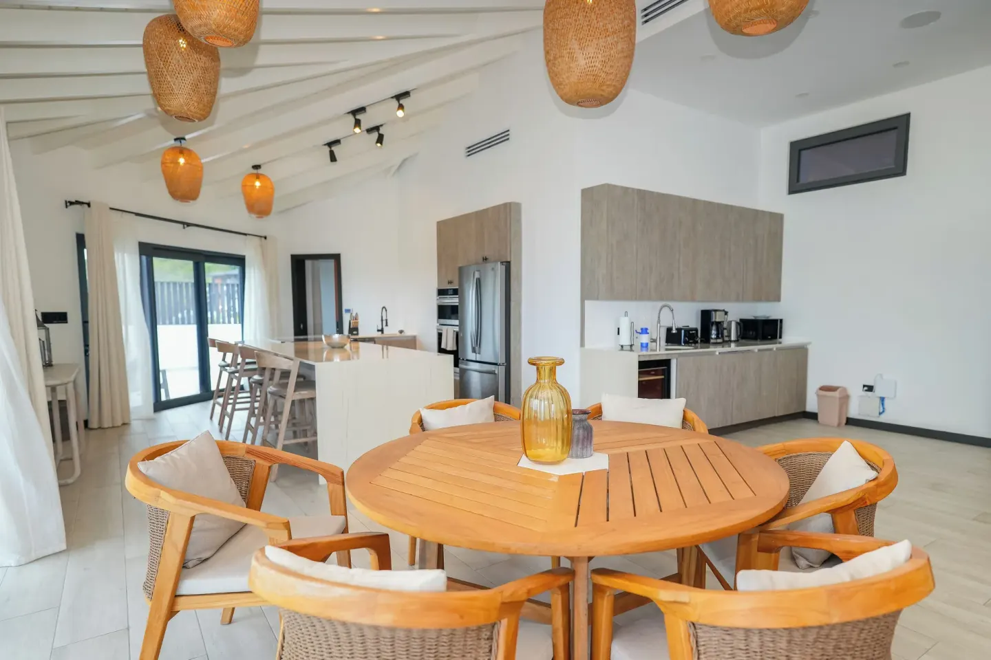 Ocean 19 living and kitchen area with round dining table at Tamarind Hills Resort & Villas.