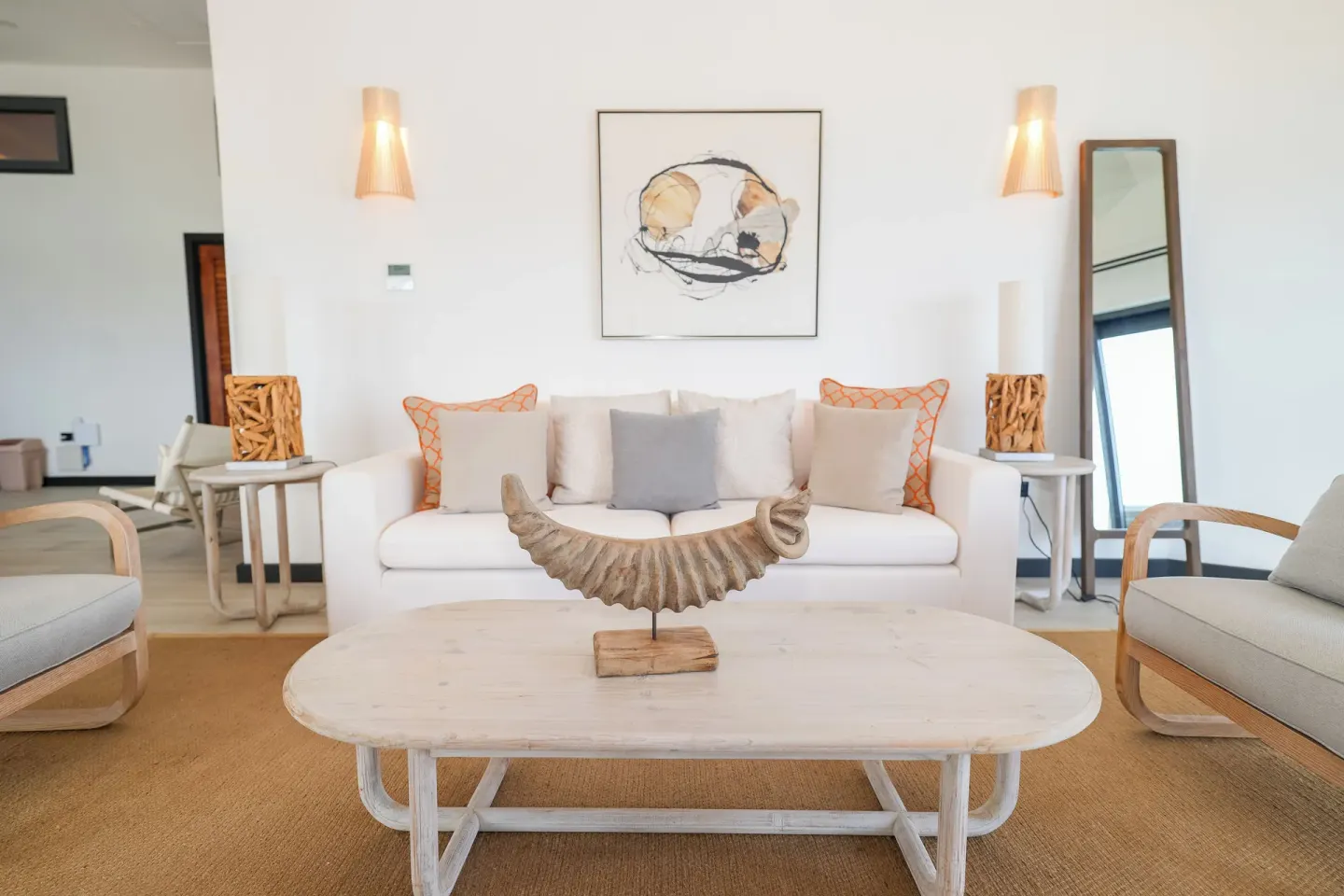 Ocean 19 lounge with white sofa and shell sculpture at Tamarind Hills Resort & Villas.