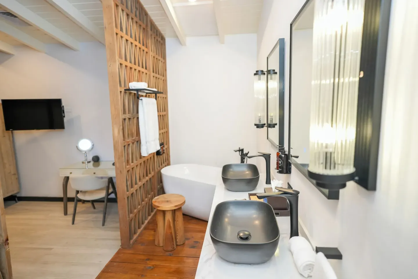 Open bathroom and vanity area in Room 19 at Tamarind Hills Resort & Villas with tub and double sinks.