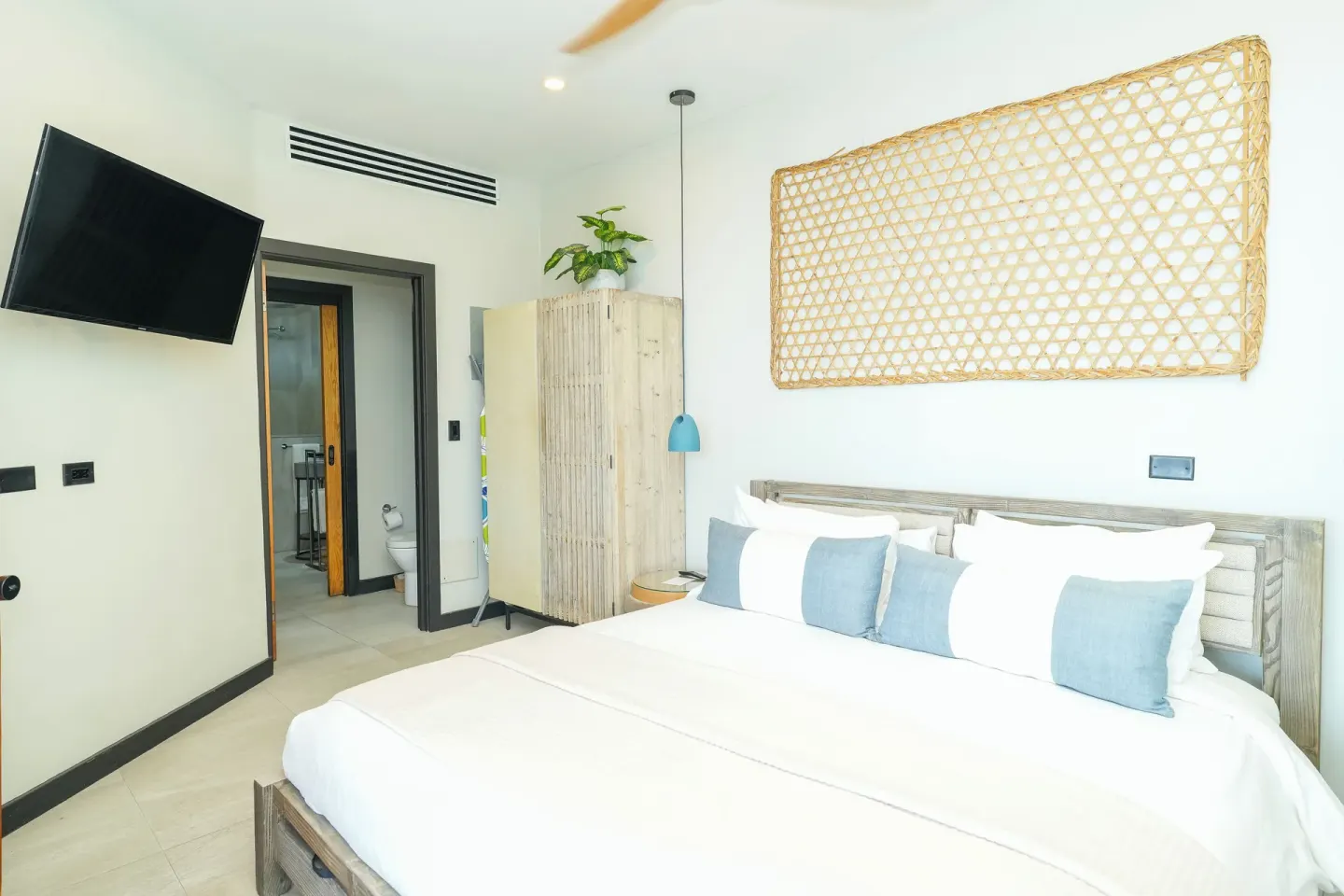 Seastar bedroom with king bed and wall-mounted TV at Tamarind Hills Resort & Villas.