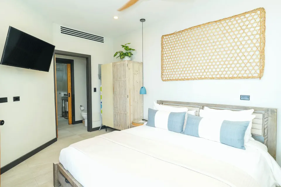 Seastar bedroom with king bed and wall-mounted TV at Tamarind Hills Resort & Villas.