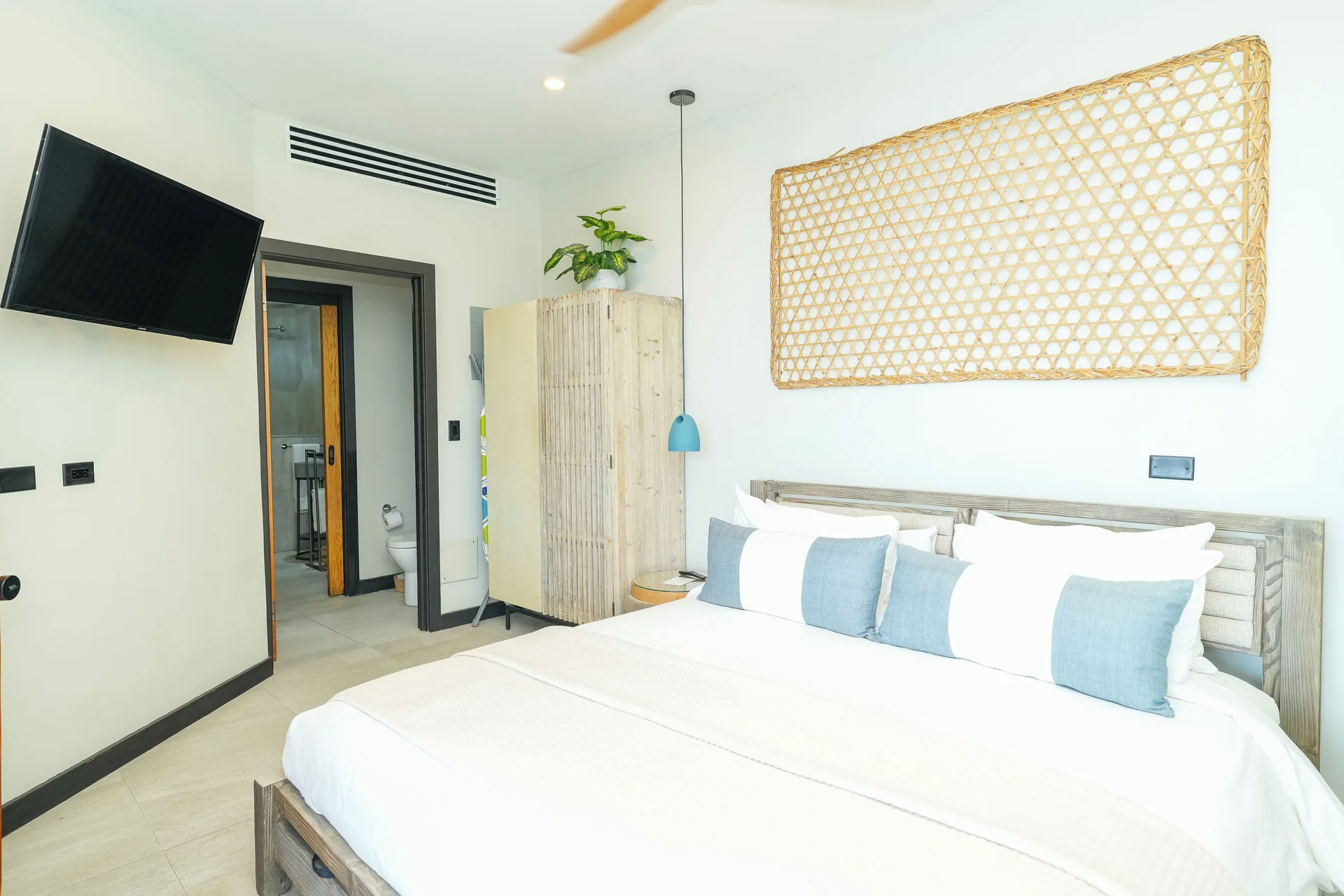 Seastar bedroom with king bed and wall-mounted TV at Tamarind Hills Resort & Villas.