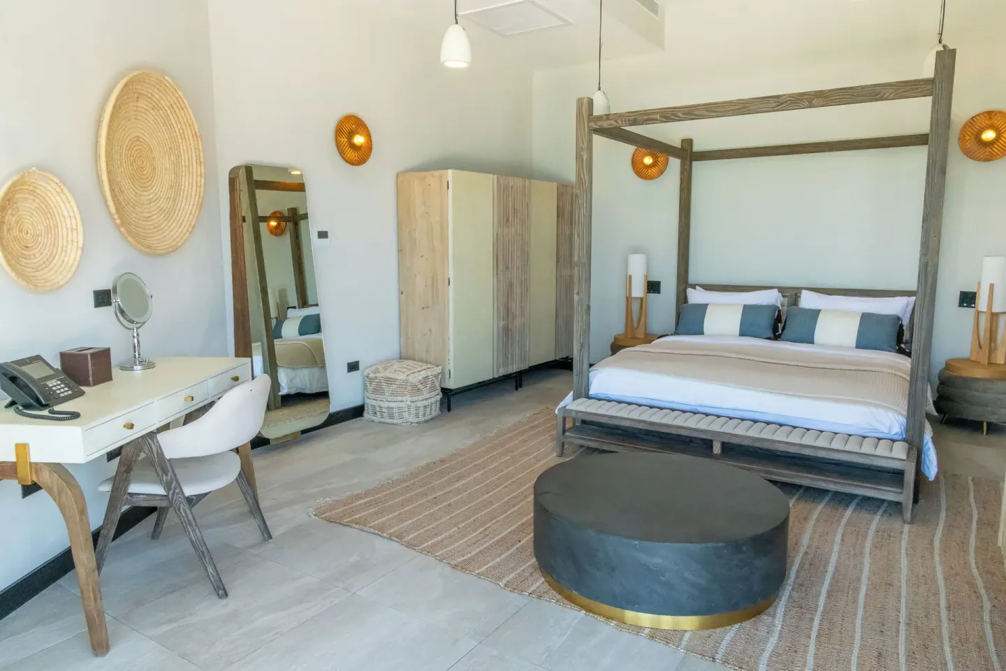 Sunset Vista room with four-poster bed and vanity at Tamarind Hills Resort & Villas.
