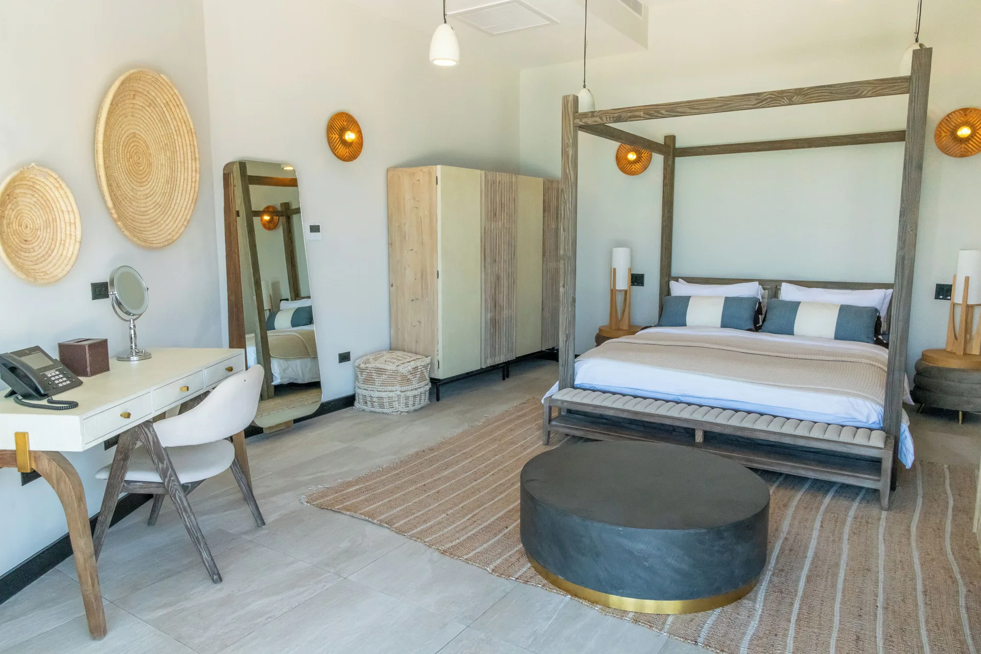 Suites 3 Bedroom at Tamarind Hills Resort and Villas with four-poster king bed, vanity, and tropical Caribbean ambiance in Antigua.