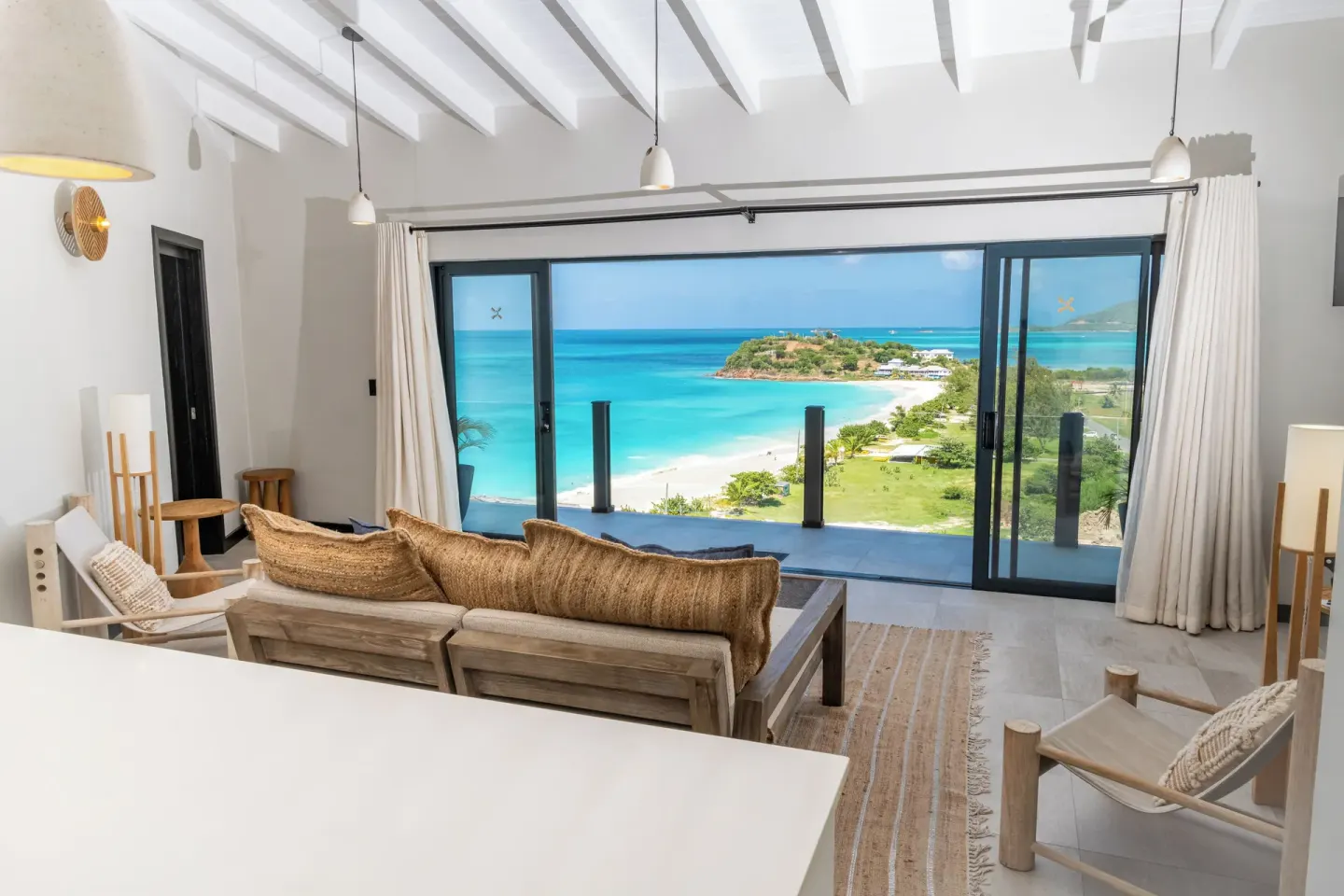 Sunset Vista living area with balcony and beach view at Tamarind Hills Resort & Villas.