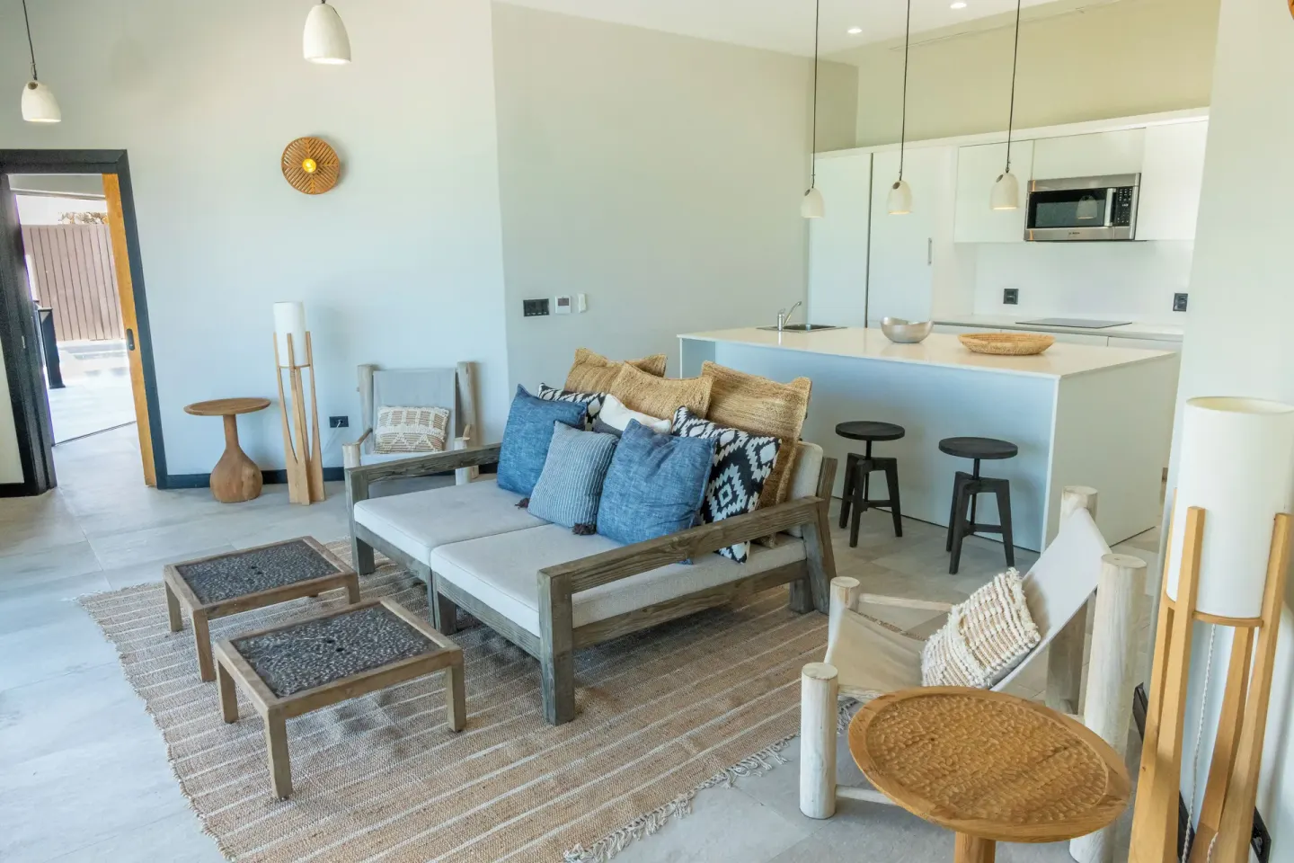 Sunset Vista room living area with sofa and kitchenette at Tamarind Hills Resort & Villas.