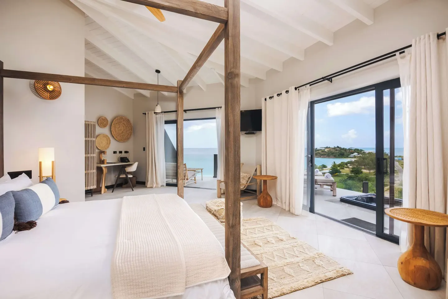 Studio ocean view room with four-poster bed at Tamarind Hills Resort & Villas.