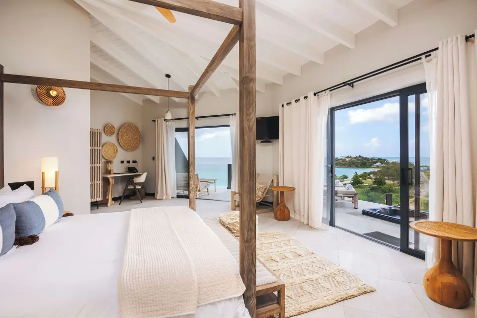 Studio ocean view room with four-poster bed at Tamarind Hills Resort & Villas.