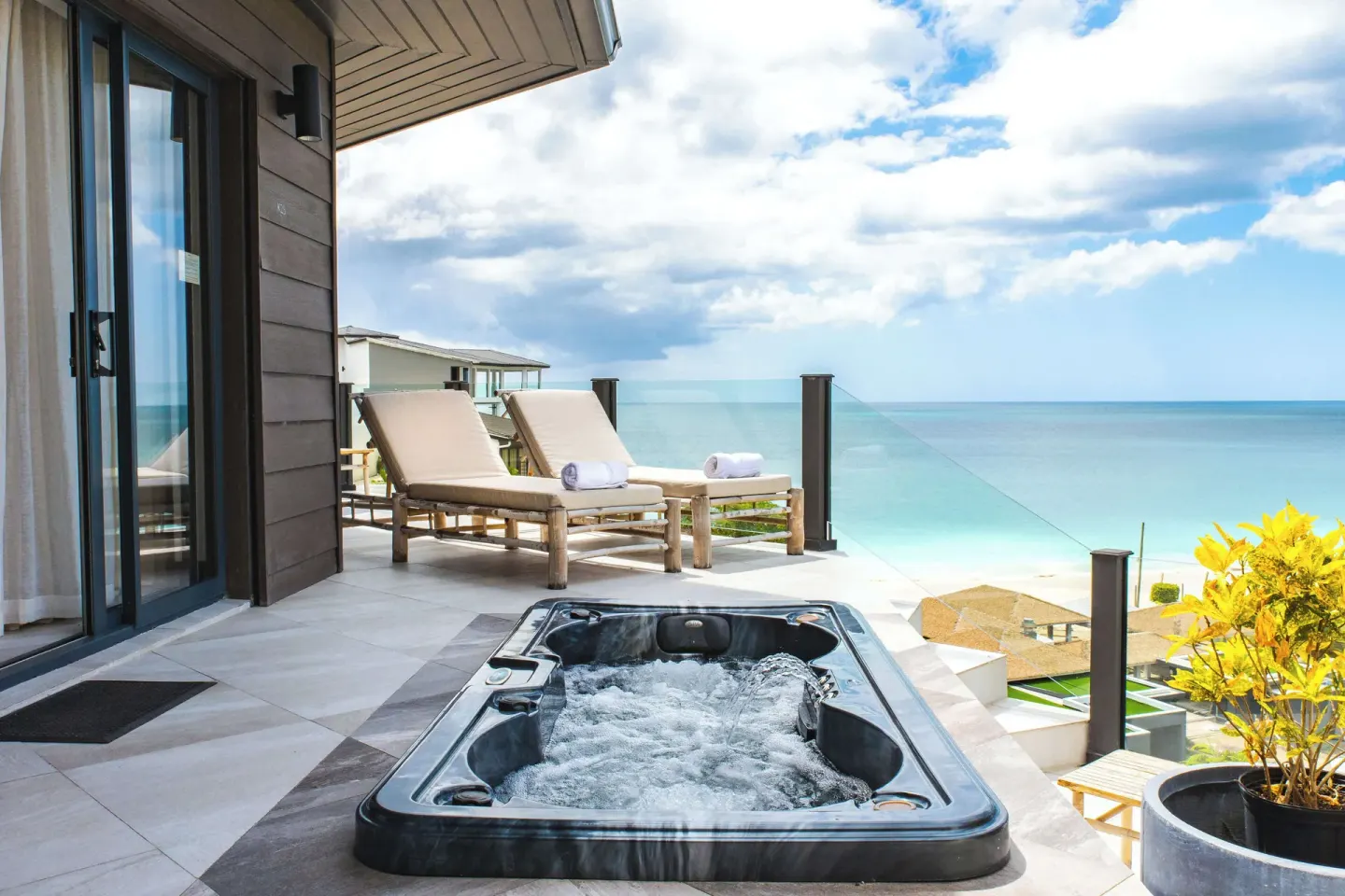 Studio terrace with jetted tub and ocean view at Tamarind Hills Resort & Villas.