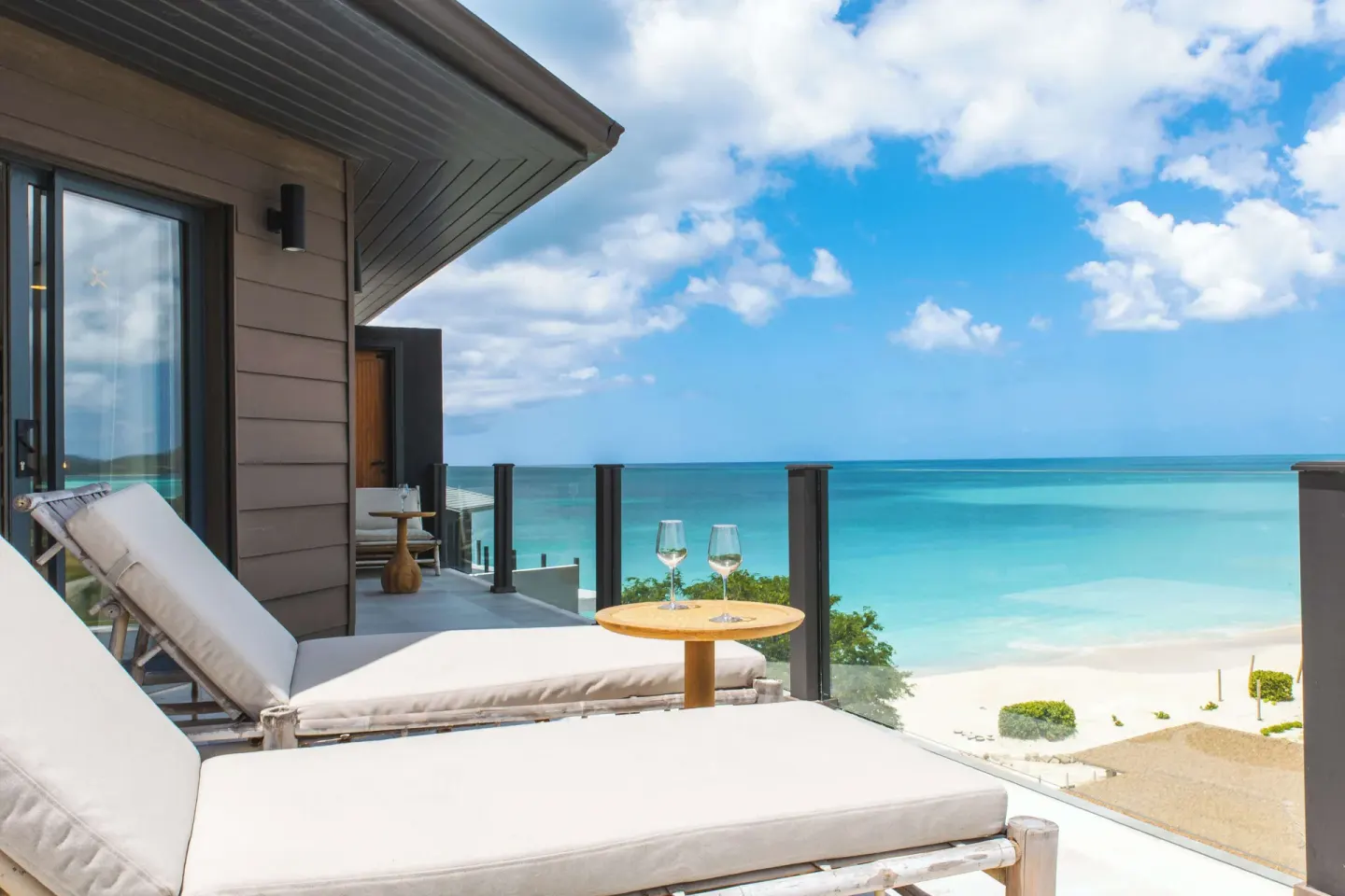 Studio Ocean View balcony with loungers and turquoise sea at Tamarind Hills Resort & Villas.