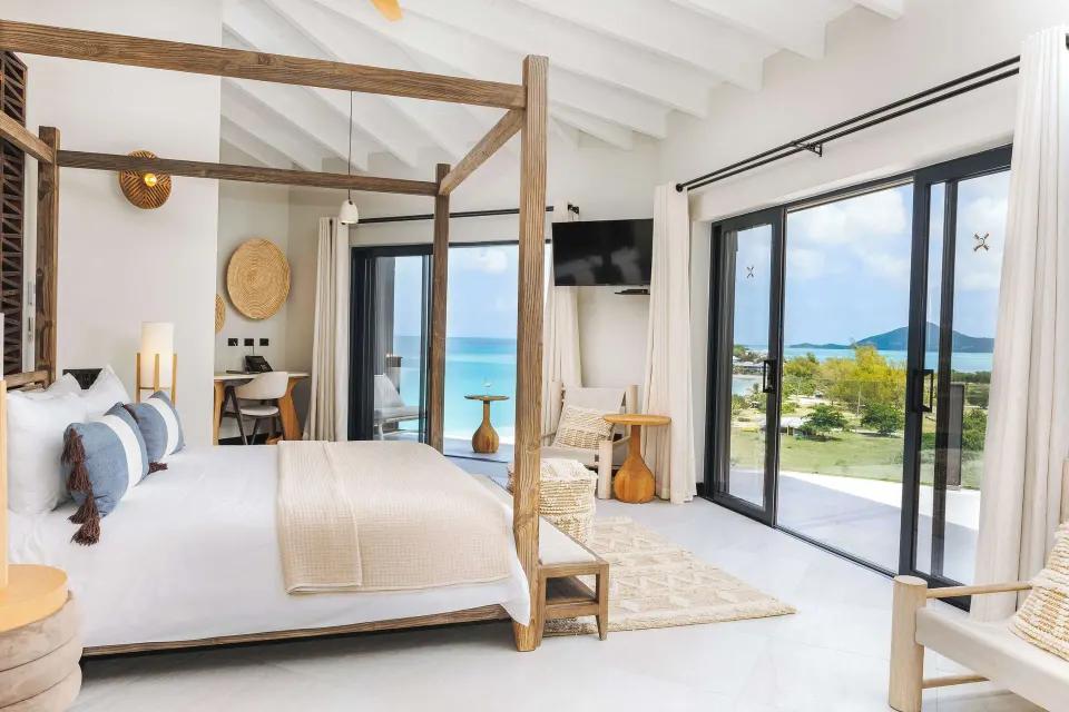 Studio Ocean View room with four-poster bed and sea-facing balcony at Tamarind Hills Resort & Villas.