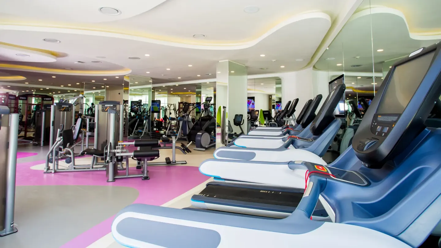 Treadmills and strength machines fill the fitness room at Temptation Cancún.
