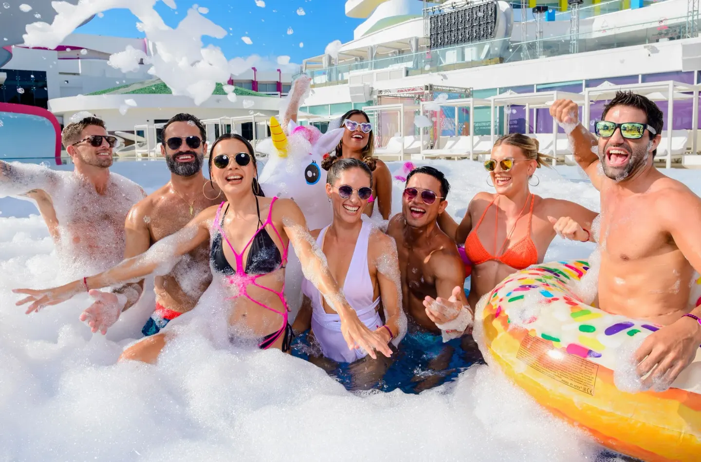 Group of guests playing in foam at the pool at Temptation Cancún.