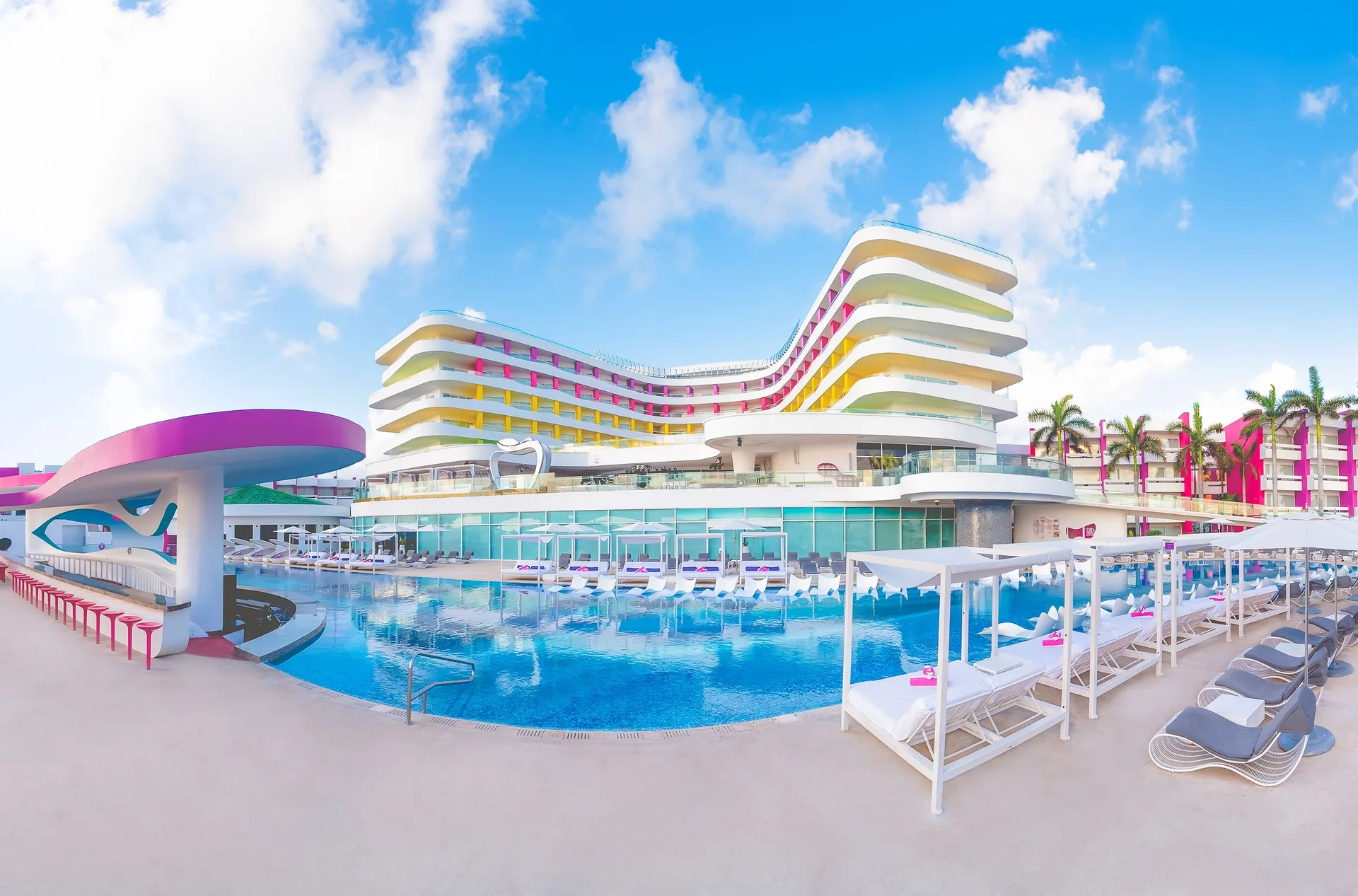 Main pool and curved hotel tower at Temptation Cancún.
