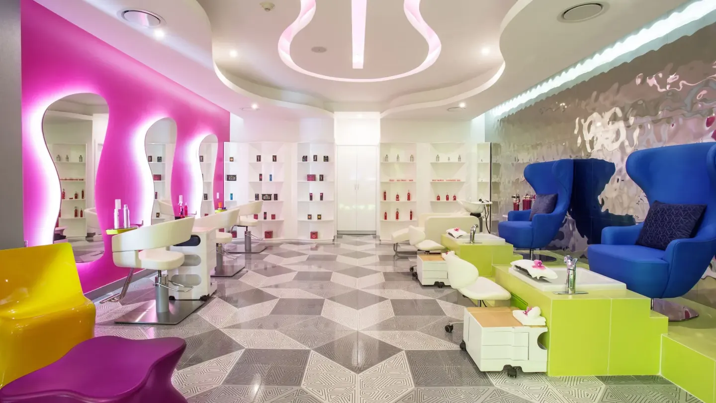 Colorful salon chairs and pedicure stations at Temptation Cancún.