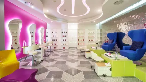 Colorful salon chairs and pedicure stations at Temptation Cancún.