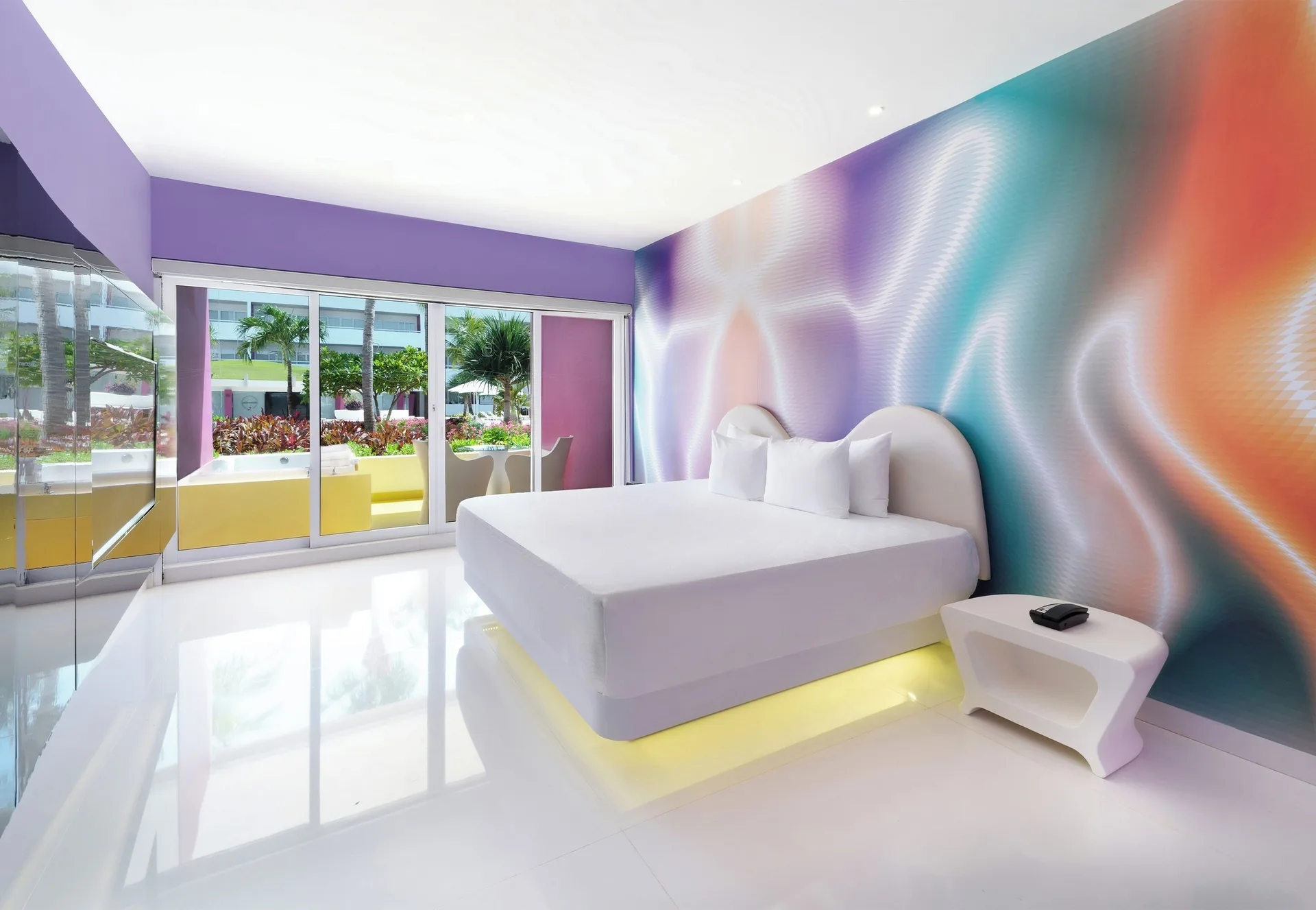 Plush Jacuzzi Ocean View/Garden View room with king bed and balcony doors at Temptation at The Tower Cancún.