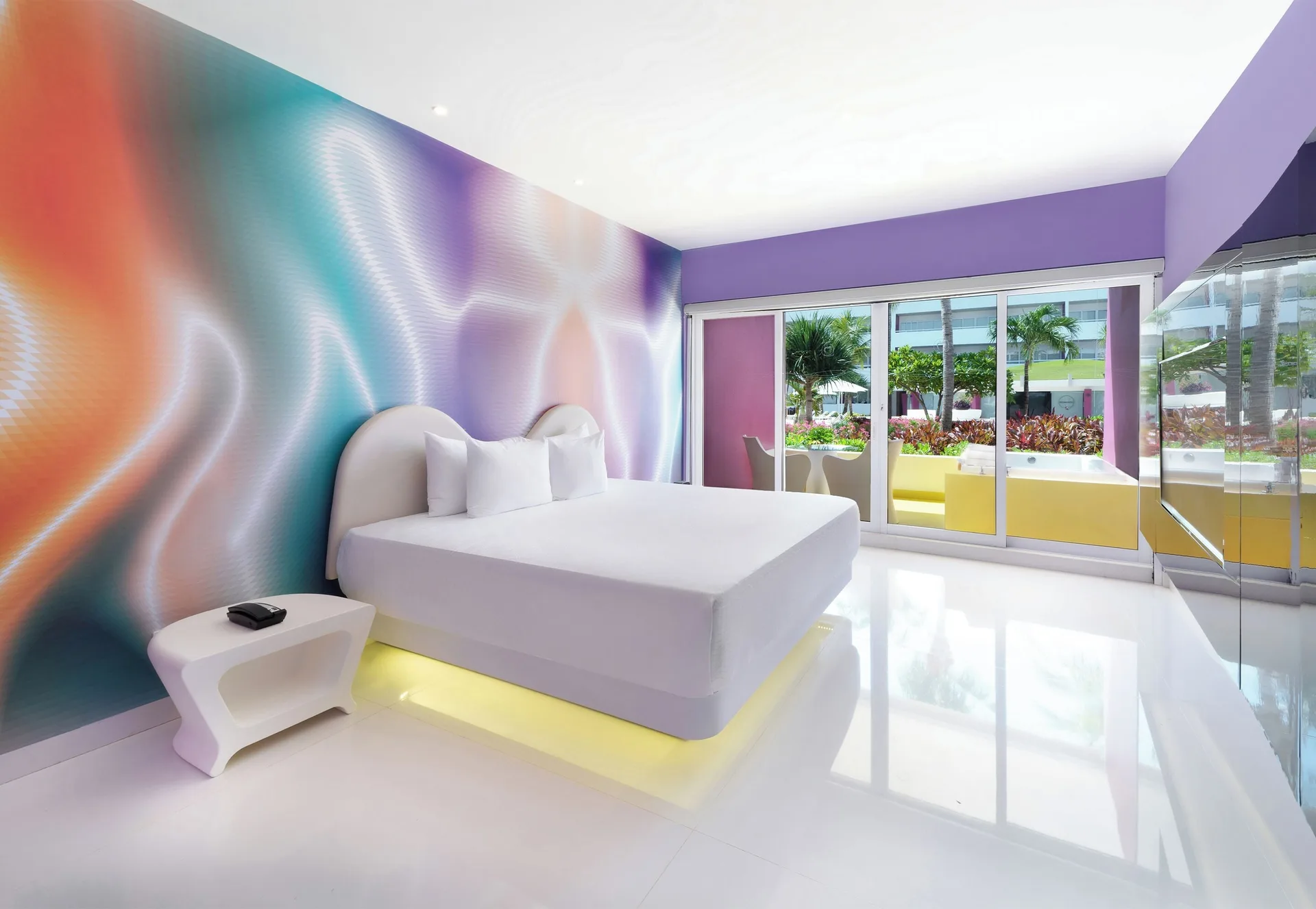 Plush Jacuzzi Ocean View/Garden View room bed and patio at Temptation at The Tower Cancún.