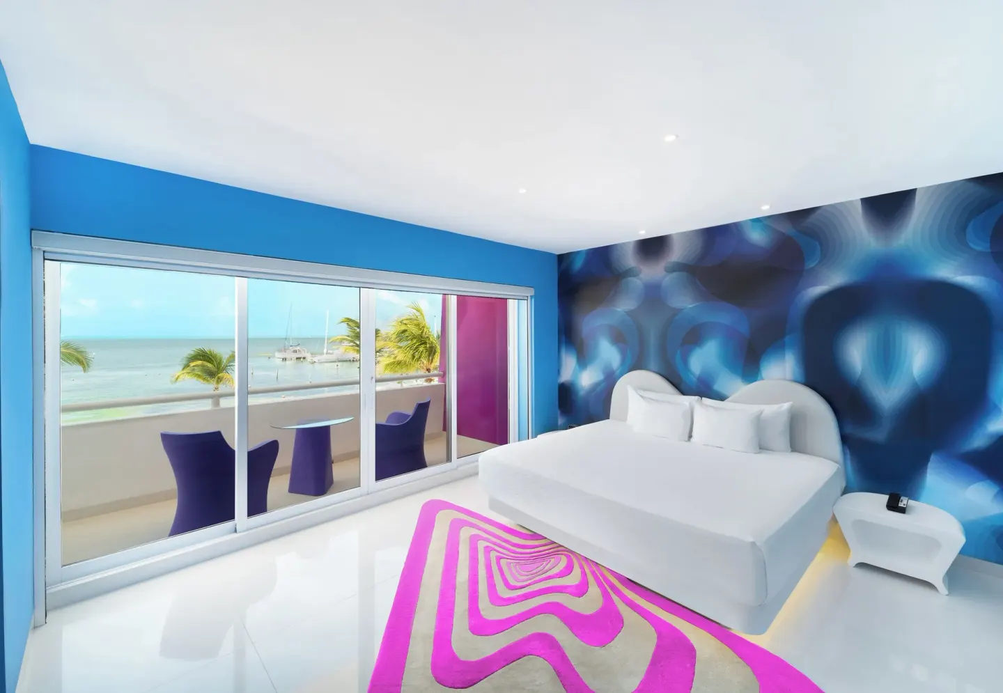 Seduction Beachfront Suite king bed and balcony at Temptation at The Tower Cancún.