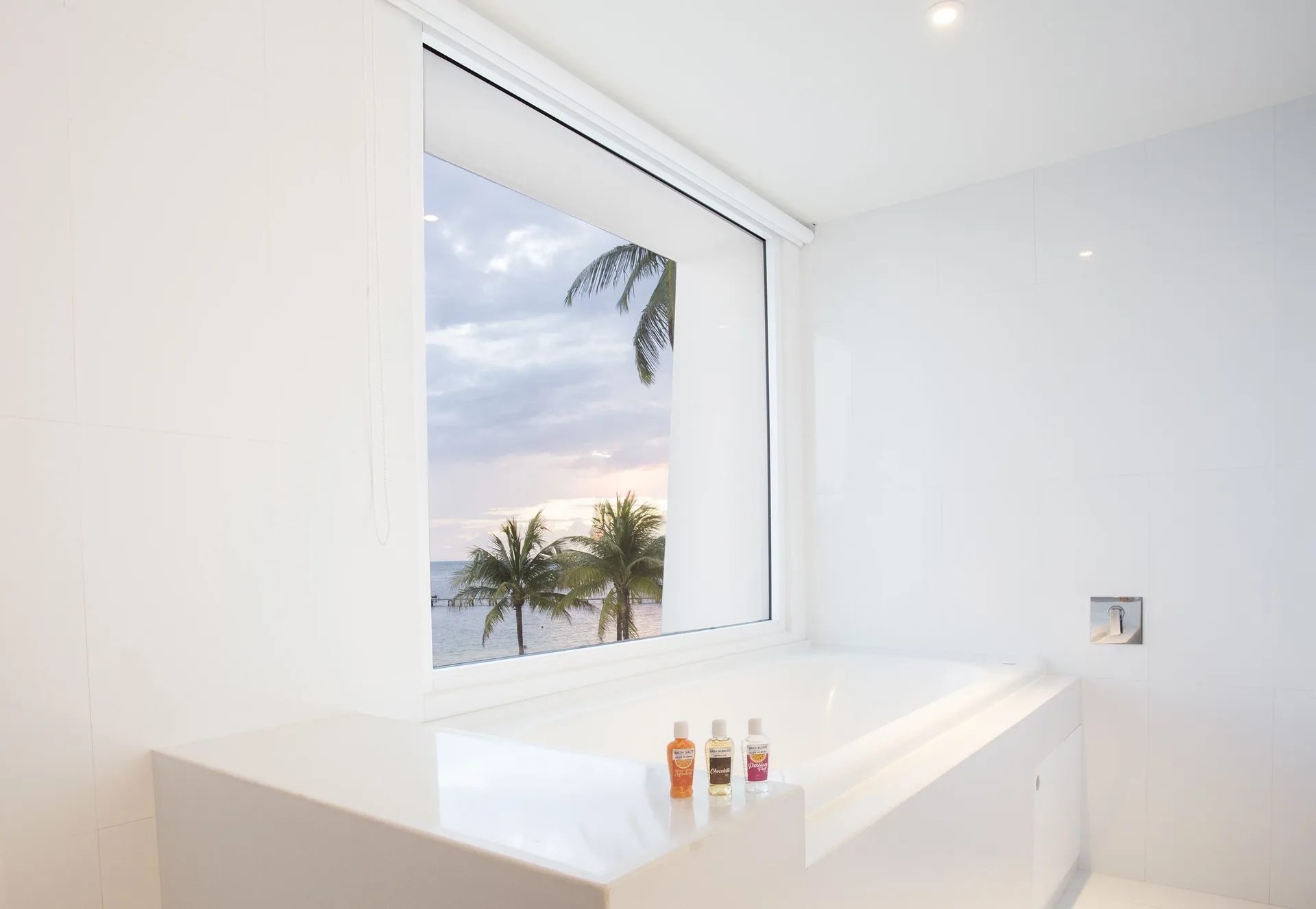 Seduction Beachfront Suite white soaking tub by a window at Temptation at The Tower Cancún.