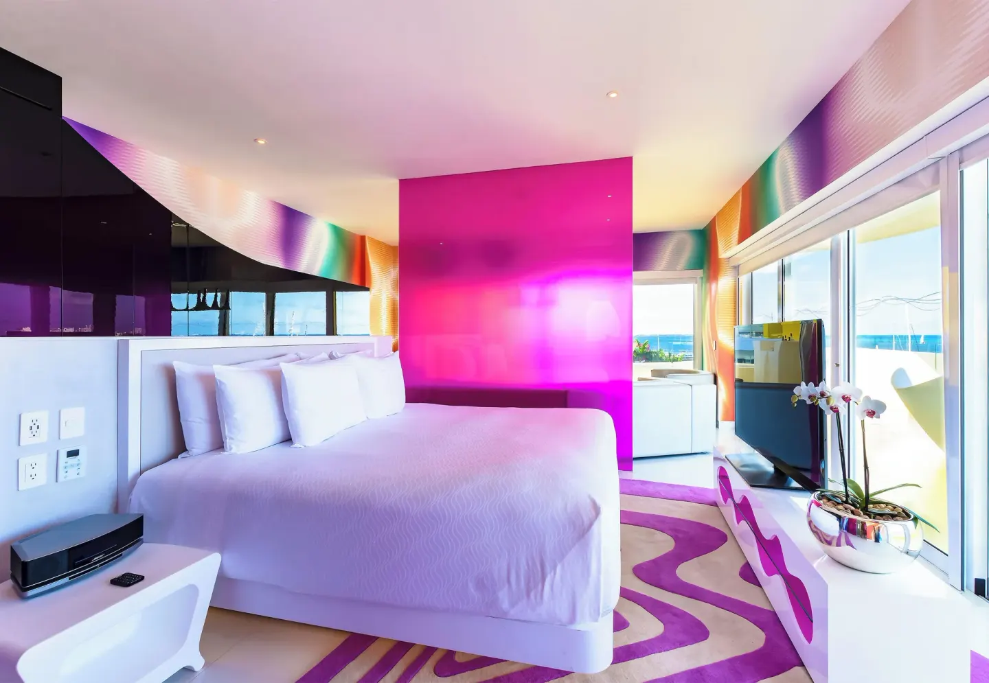 Oceanfront Master Suite bedroom with balcony windows at Temptation at The Tower Cancún.