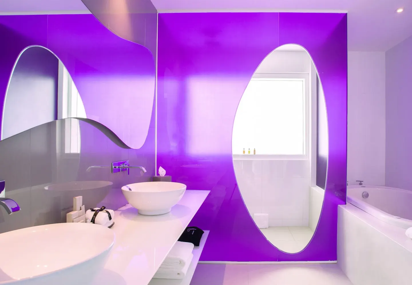 Oceanfront Master Suite bathroom with oval mirrors and tub at Temptation Cancún.