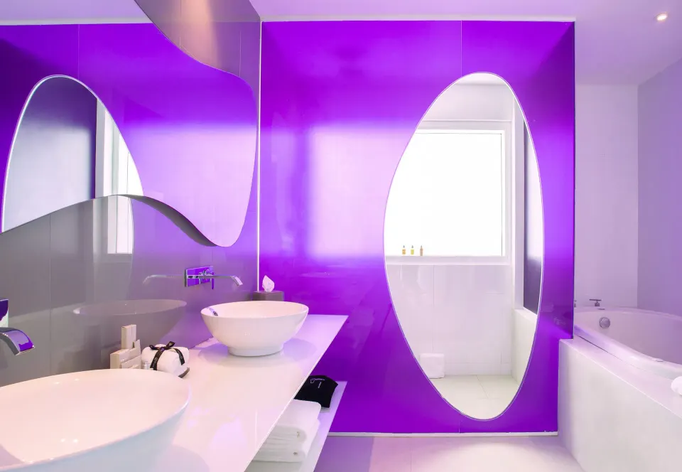 Oceanfront Master Suite bathroom with oval mirrors and tub at Temptation Cancún.