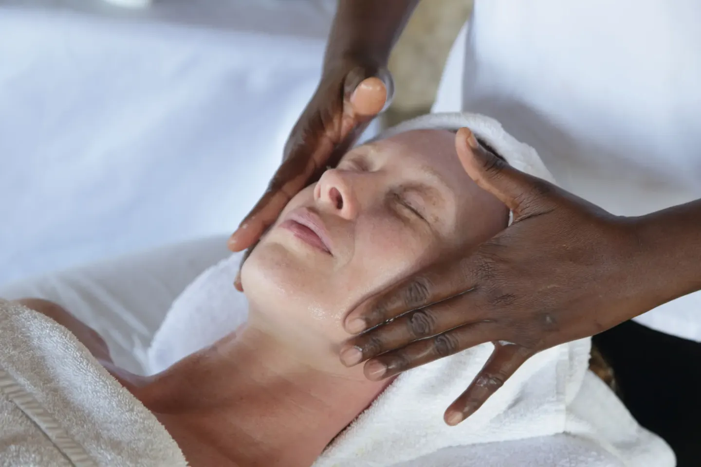Spa therapist massages a guest’s face during a facial at Tensing Pen Hotel.