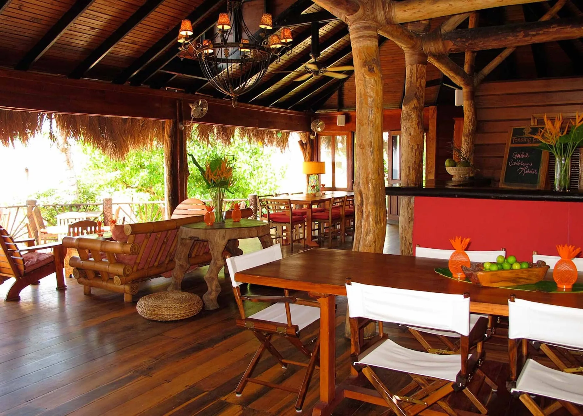 Open-air wooden dining lounge with thatched details at Tensing Pen Hotel.