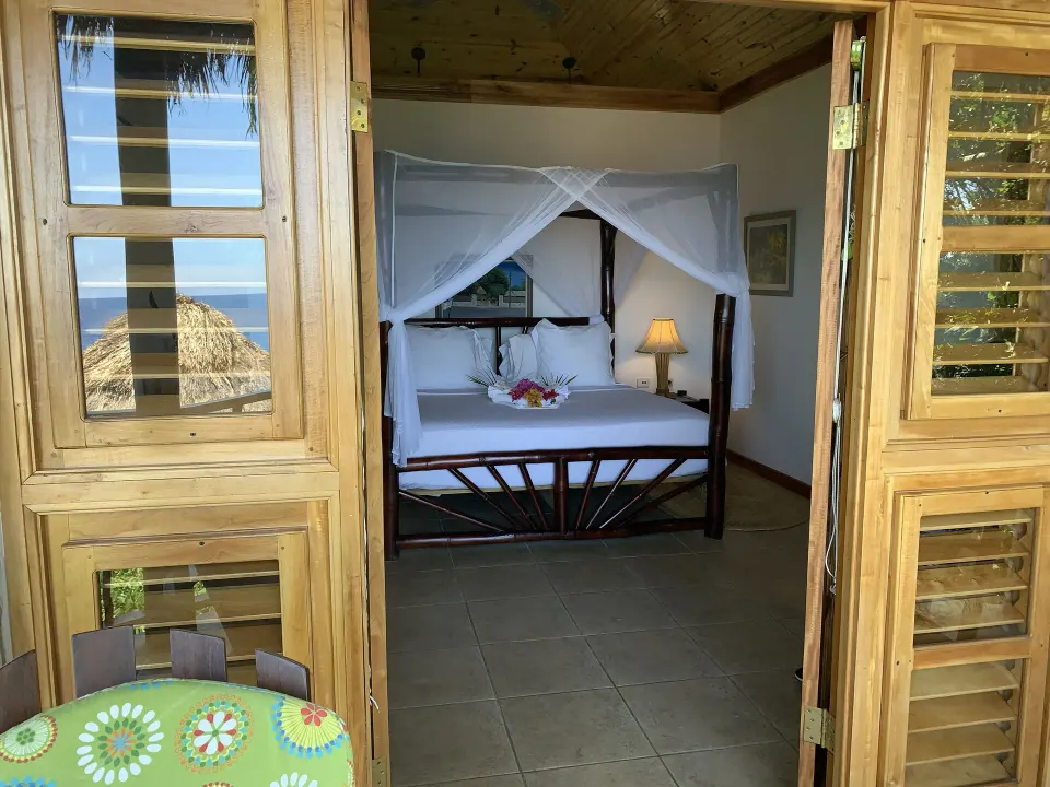 Deluxe Room Ocean View seen through open wood doors at Tensing Pen Hotel.