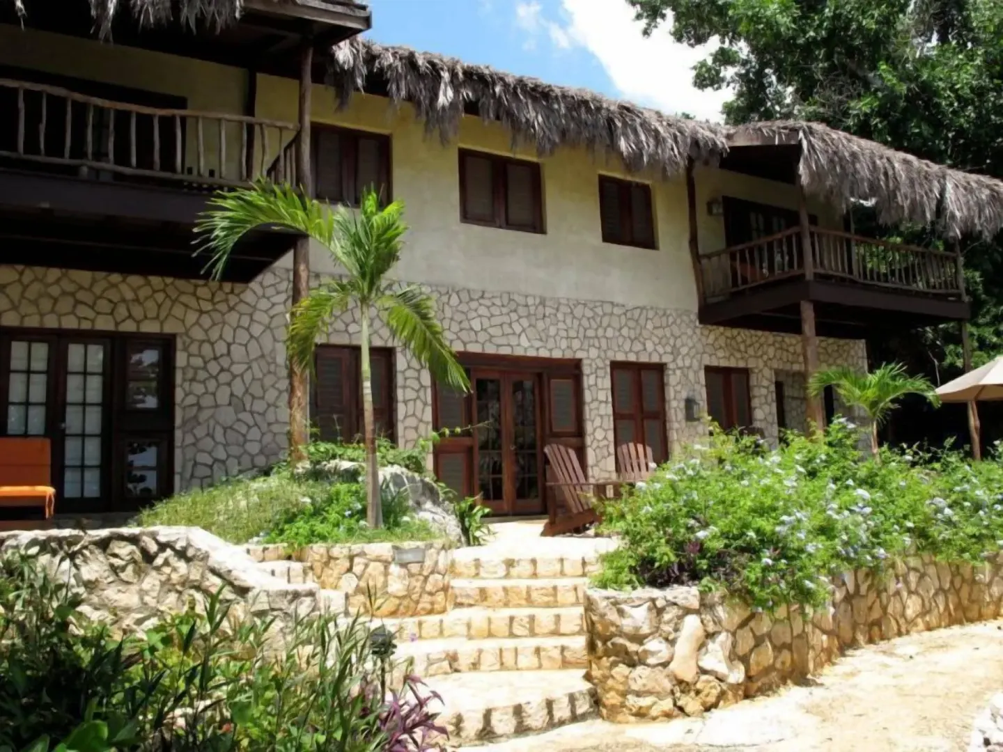 Panoramic Villa exterior with balconies and gardens at Tensing Pen Hotel.