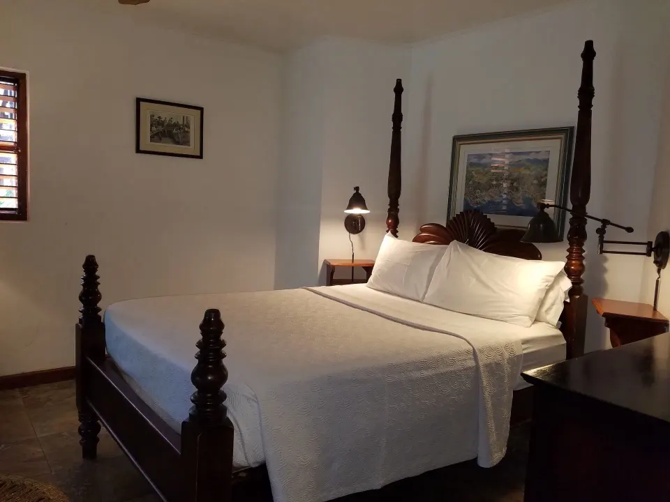 Superior Garden View bedroom with four-poster bed at Tensing Pen Hotel.