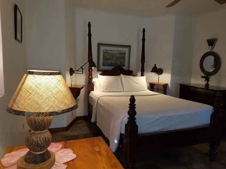Superior Garden View bedroom with bedside lamp at Tensing Pen Hotel.