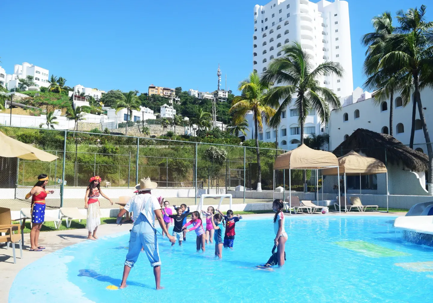 Children join pool activities in a shallow pool at Tesoro Manzanillo.