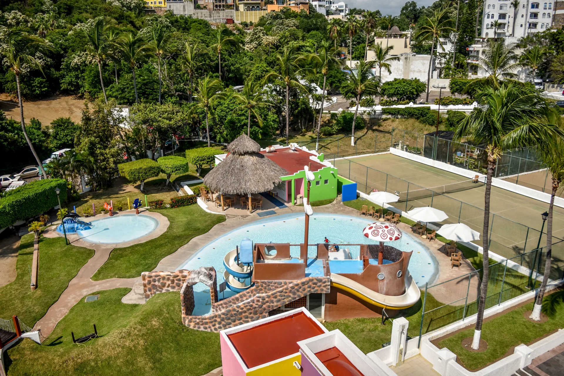 Aerial view of the children's pool, slides and tennis courts at Tesoro Manzanillo.