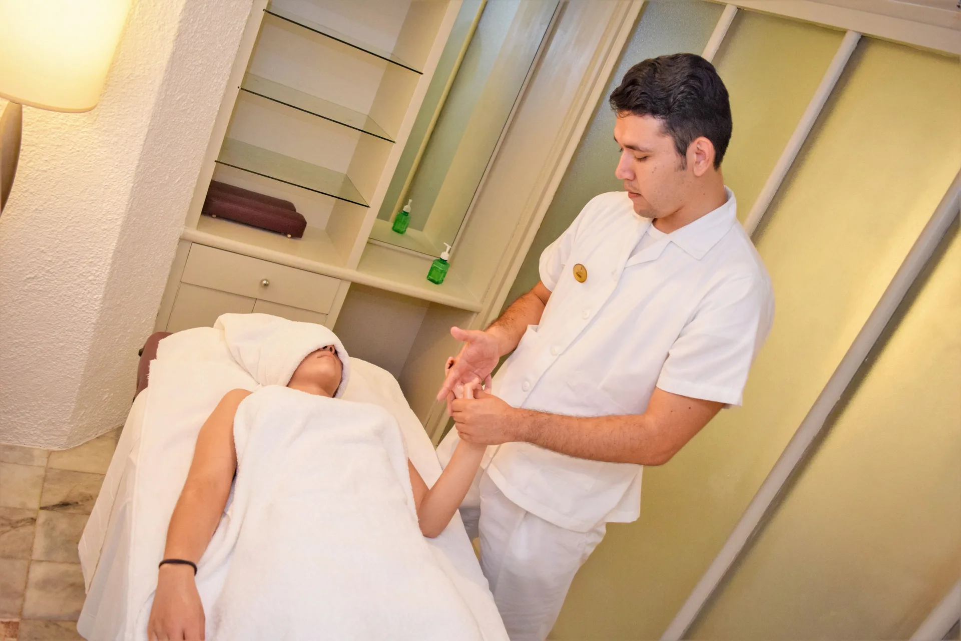 Spa service with an attendant working on a guest's hand at Tesoro Manzanillo.