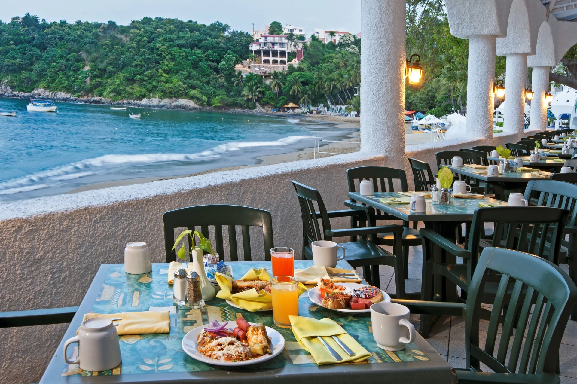 Breakfast table on a seaside terrace overlooking the bay at Tesoro Manzanillo.
