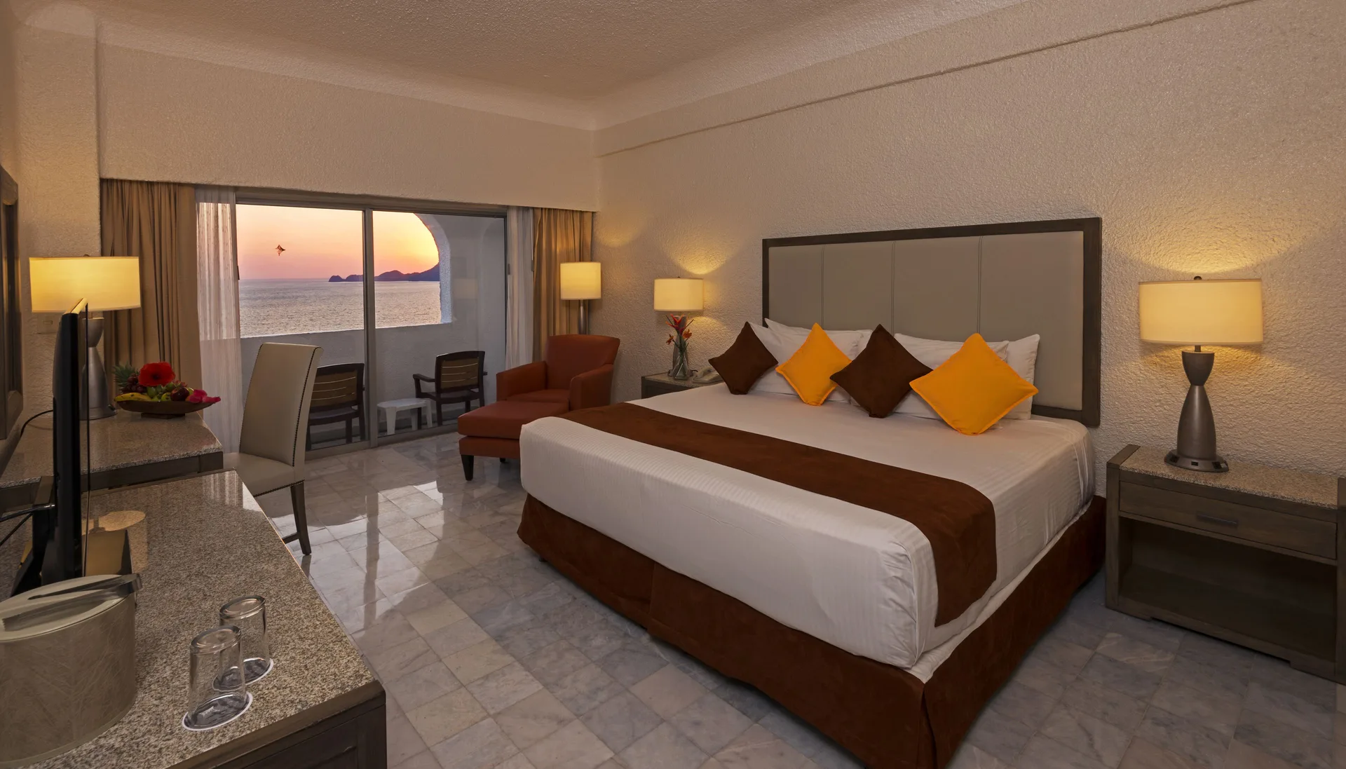 Standard Room Ocean View with king bed and sunset balcony at Tesoro Manzanillo.