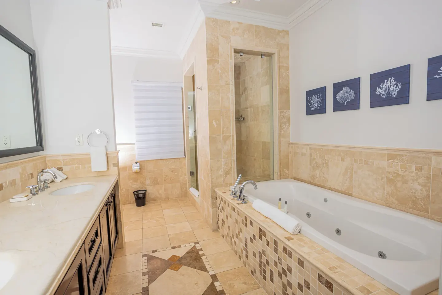 Bathroom with soaking tub, vanity, and glass shower at The Atrium Resort.