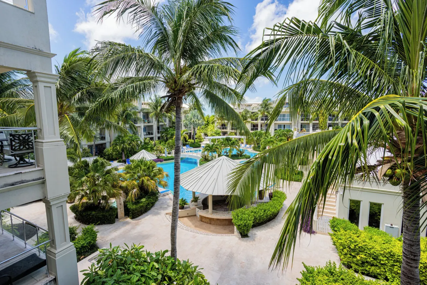 Palm-framed resort courtyard and pool view at The Atrium Resort.