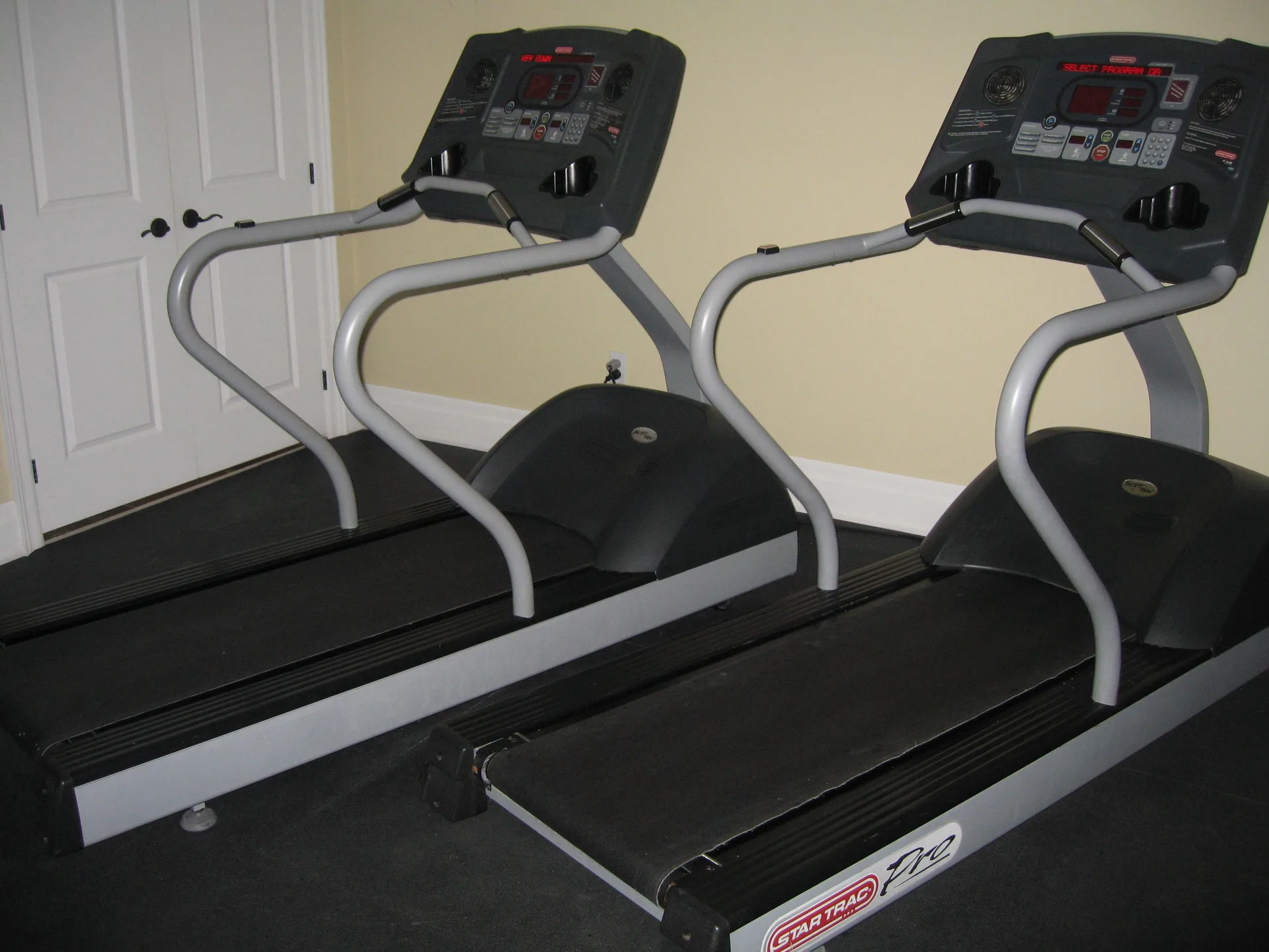 Two treadmills stand side by side in the fitness room at The Atrium Resort.