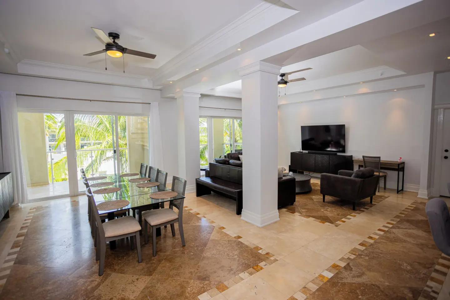 Open dining and living room with balcony doors at The Atrium Resort.