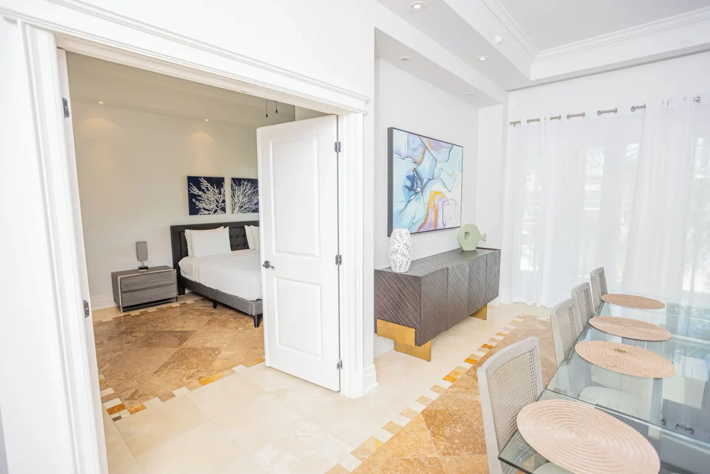 Dining area and bedroom doorway inside a suite at The Atrium Resort.