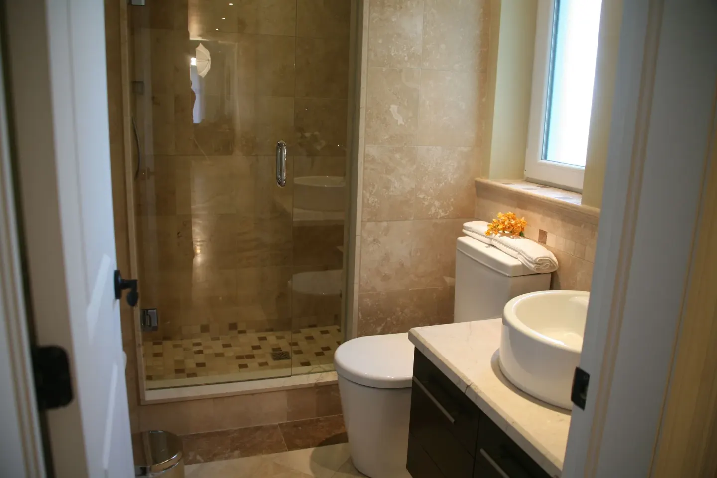 Two-bedroom condo bathroom with glass shower and vessel sink at The Atrium Resort.