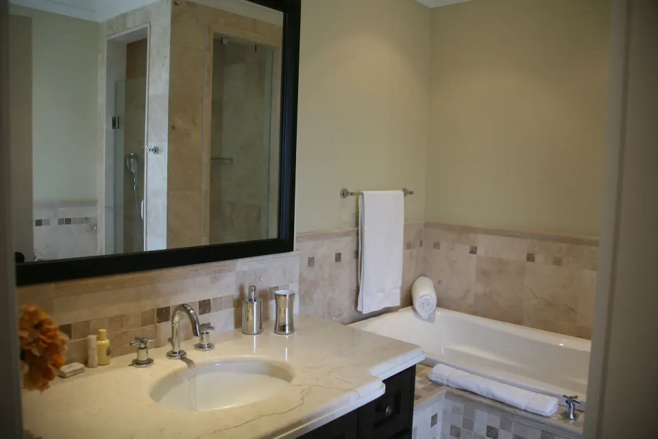 Two-bedroom condo bathroom sink and bathtub at The Atrium Resort.