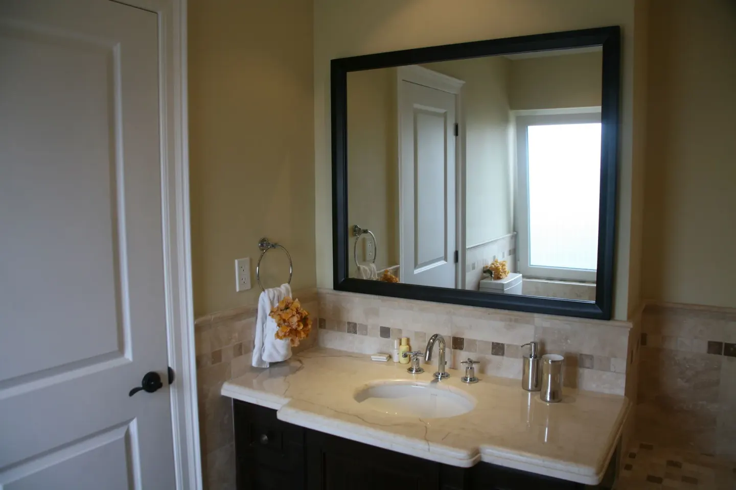 Two-bedroom condo bathroom vanity with mirror at The Atrium Resort.