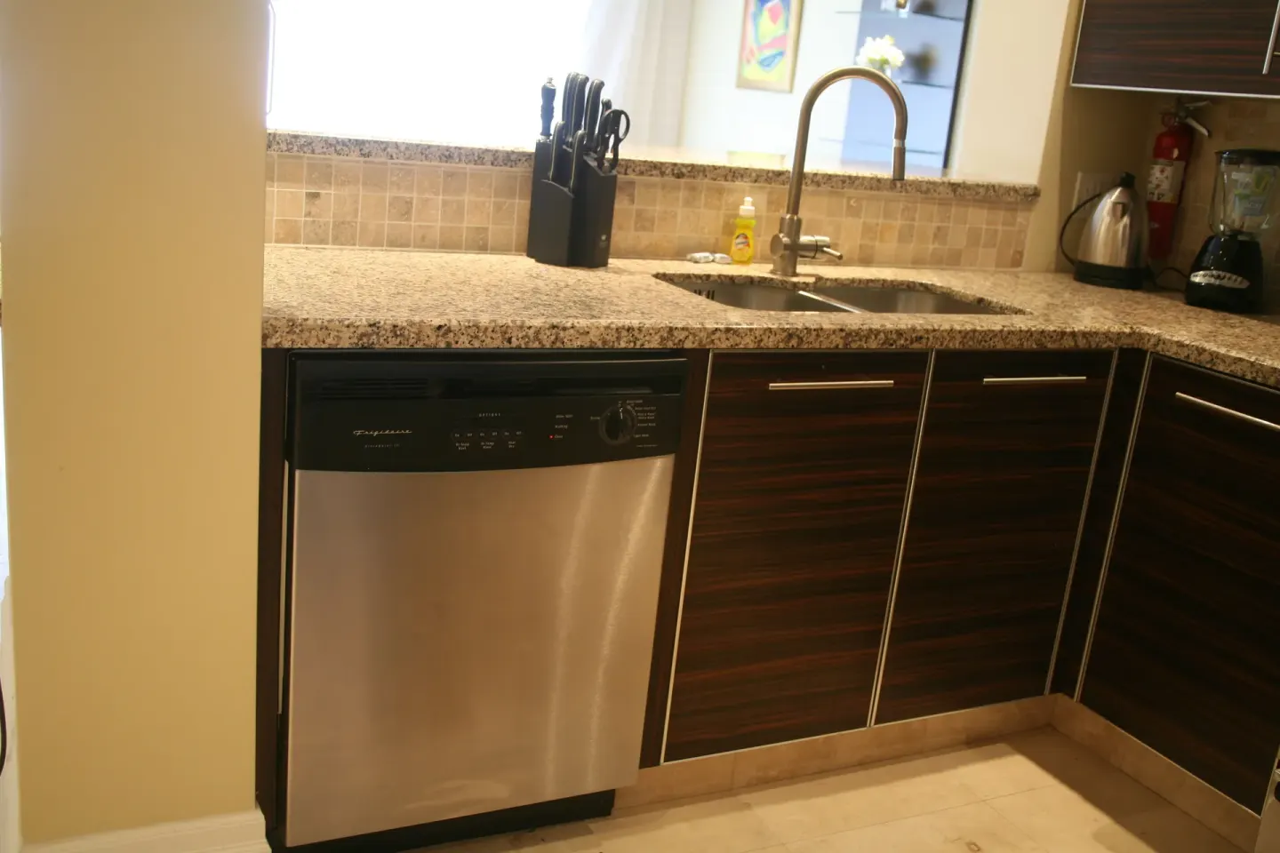 Kitchen sink, dishwasher, and countertop in a condo at The Atrium Resort.