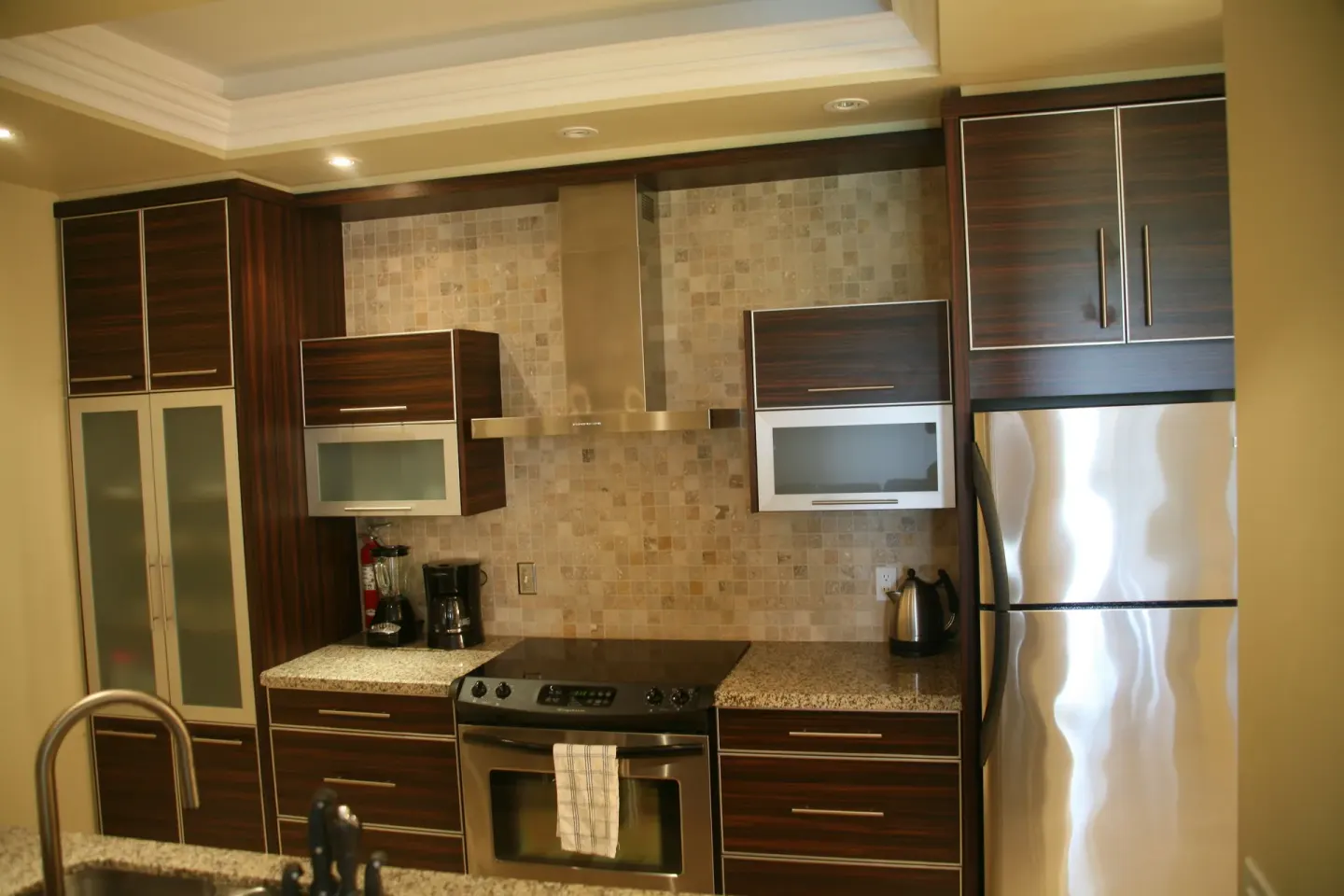 One Bedroom Condo kitchen appliances and cabinets at The Atrium Resort.
